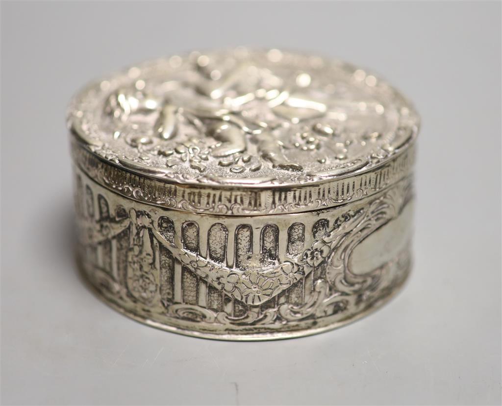 A late 19th/early 20th century German embossed 800 white metal circular box, with hinged cover, 9.5cm, 6oz.